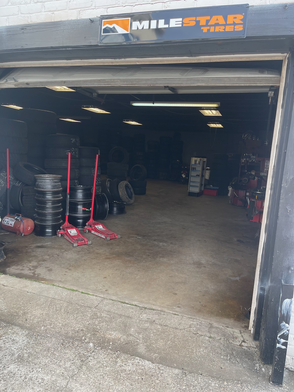 Garage bay entrance under the Milestar Tires sign