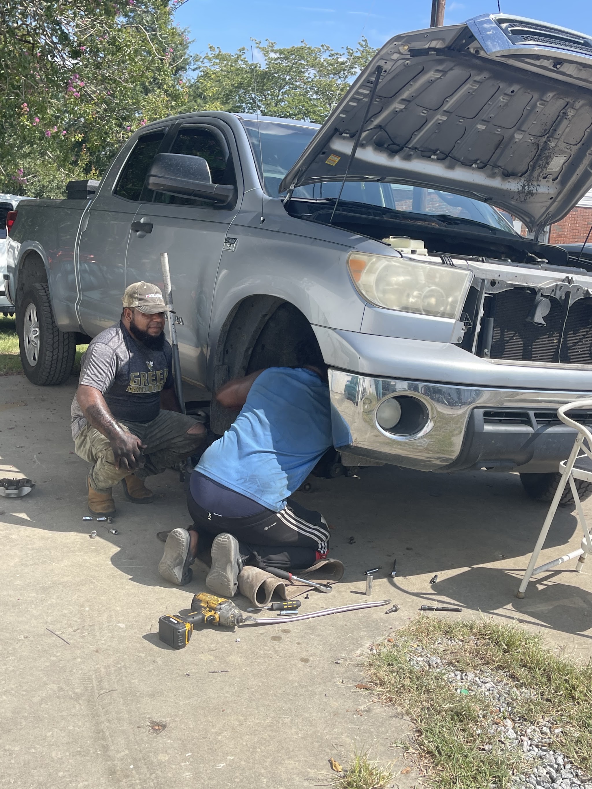 A pickup on the lot getting its tires changed